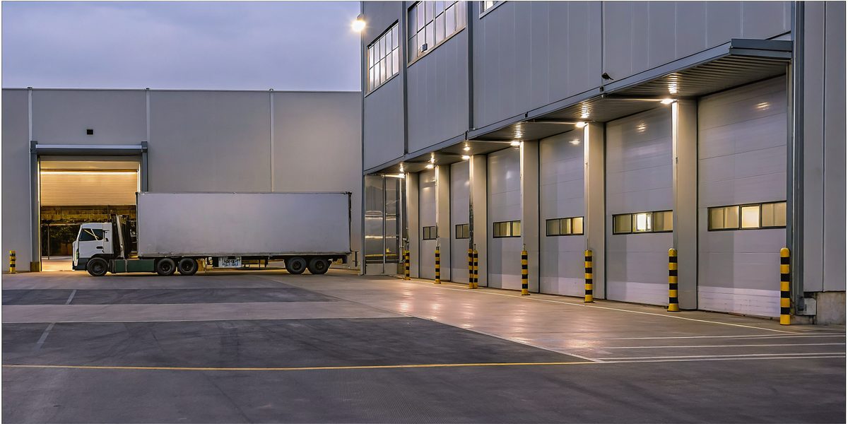 Operations professional verifying a delivery truck at a loading dock
